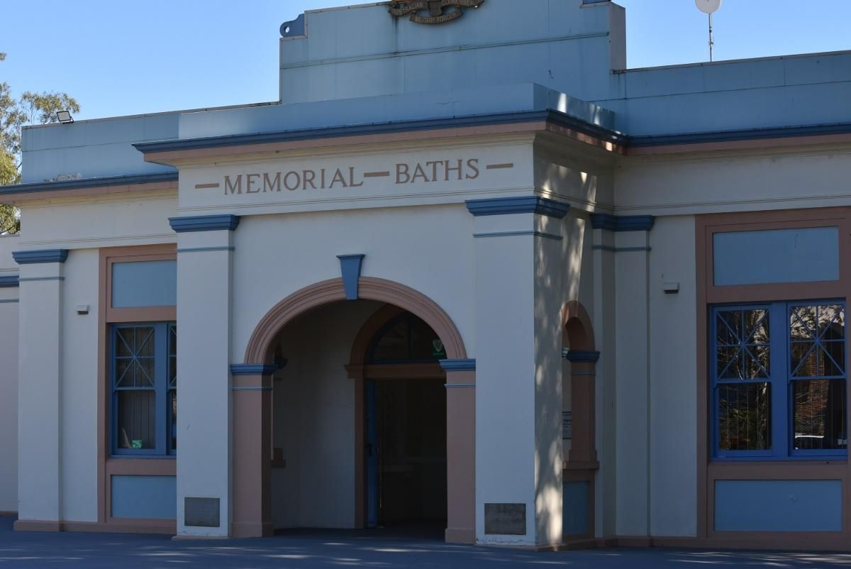 A Building with A Sign that Says Memorial Baths — S & L Sand & Gravel in Lismore, NSW