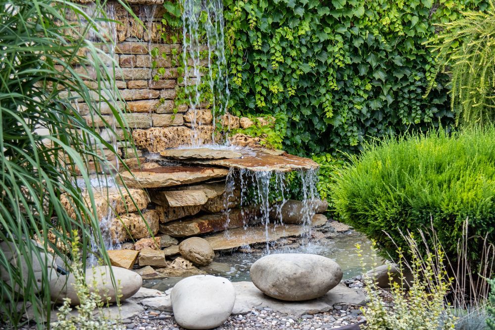 An Outdoor Water Feature Surrounded By Decorative Stones