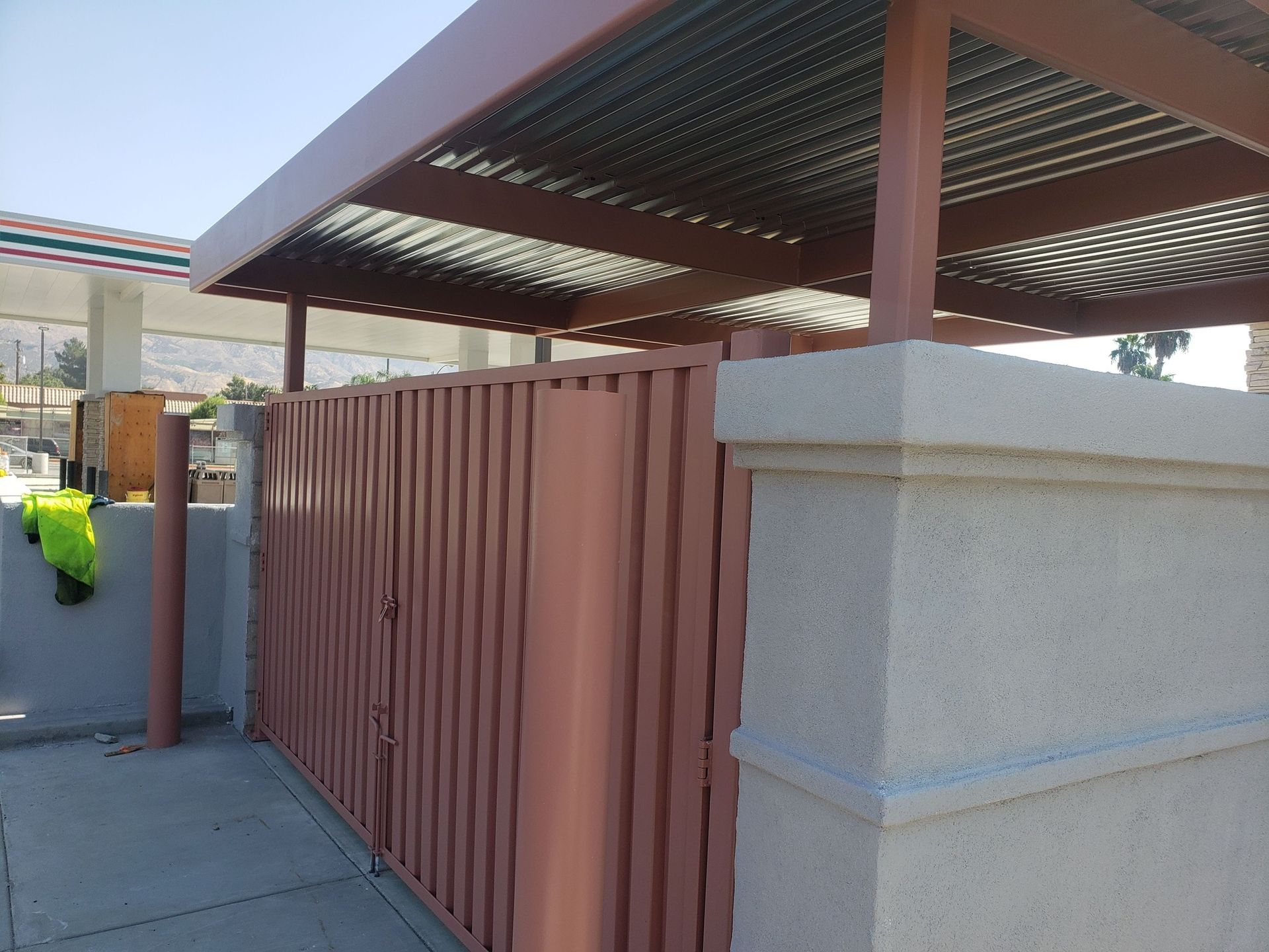 A fence with a canopy over it is next to a building