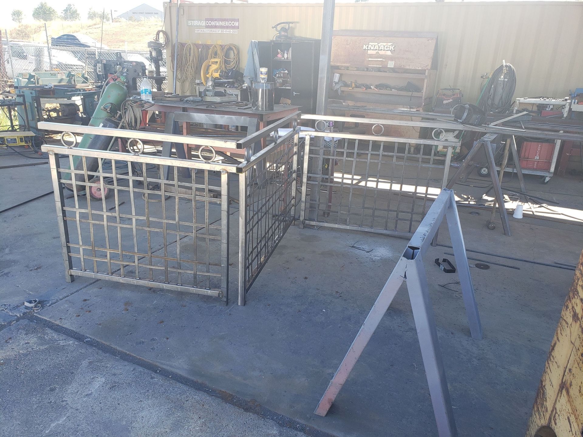 A metal fence is being built in a workshop.