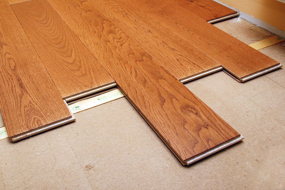 A Wooden Floor Is Being Installed In A Room — Corbett Brothers Flooring In Woy Woy, NSW