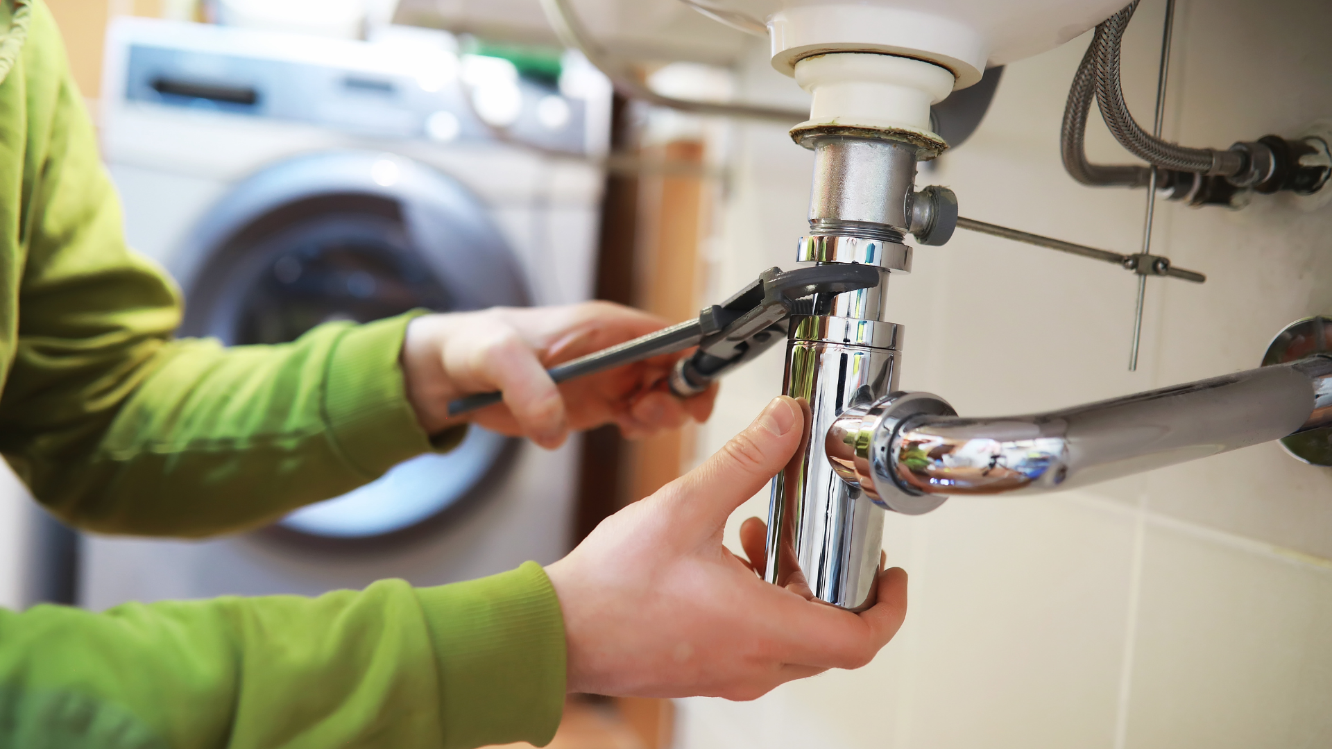 A laundry room with a sink and a washer and dryer.