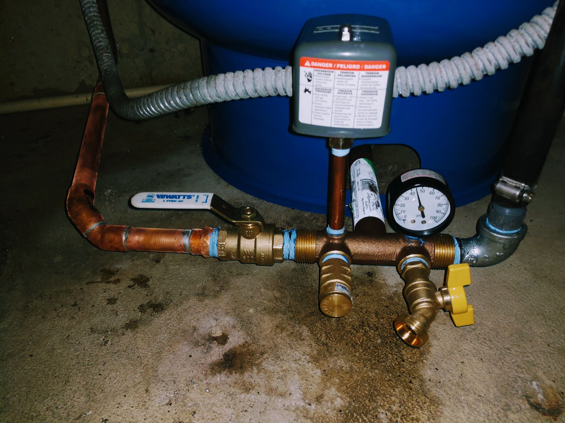 A copper pipe with a valve and a clock on it