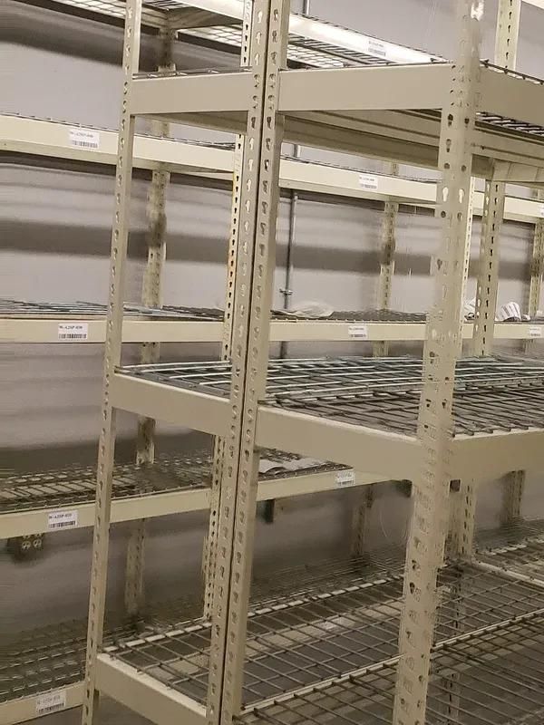A row of empty shelves in a warehouse.