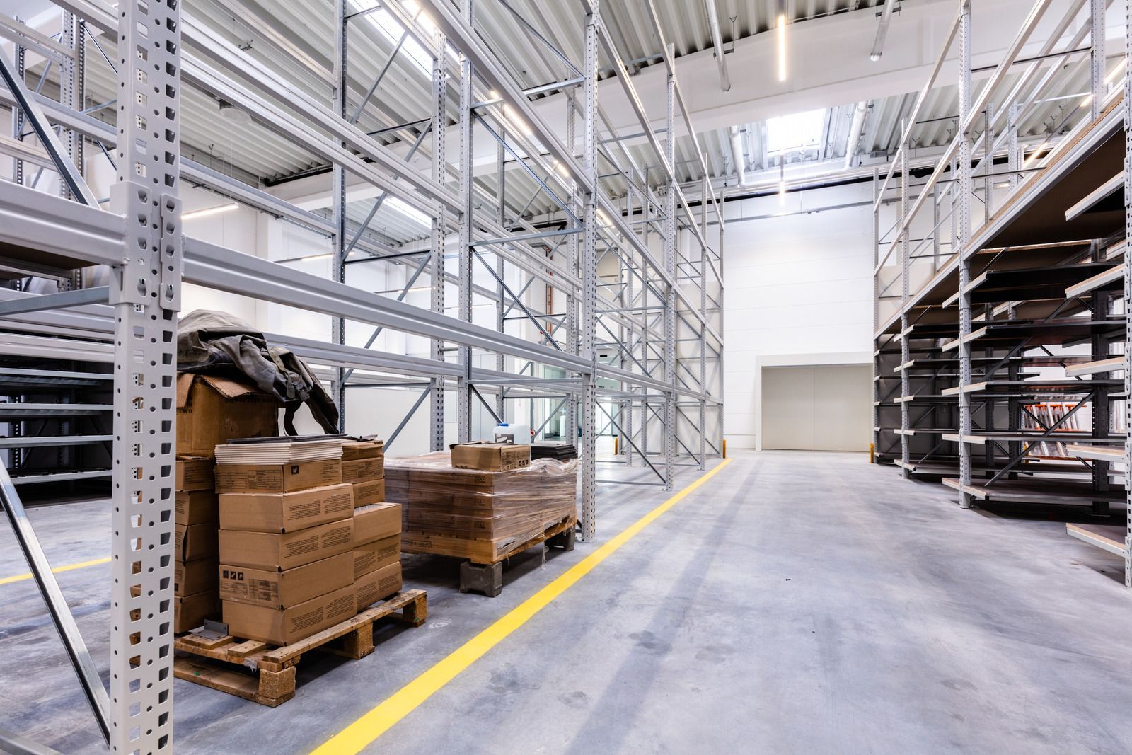 A large warehouse filled with lots of shelves and pallets.