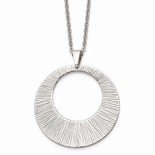Silver necklace with a large, textured circular pendant.