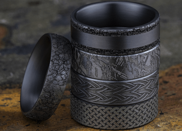 Black metal rings, stacked and arranged. Various textures and patterns are shown.