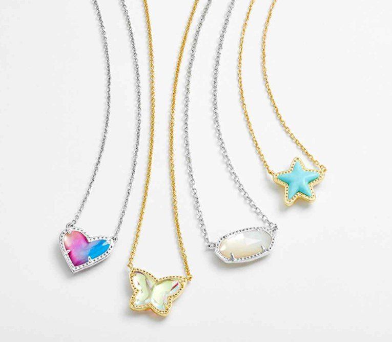 Four pendant necklaces: heart, butterfly, oval, and star-shaped, set against a white background.