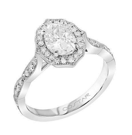 Oval diamond ring with a halo and a twisted band.