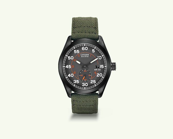 Black wristwatch with green fabric strap; gray face with orange markings.