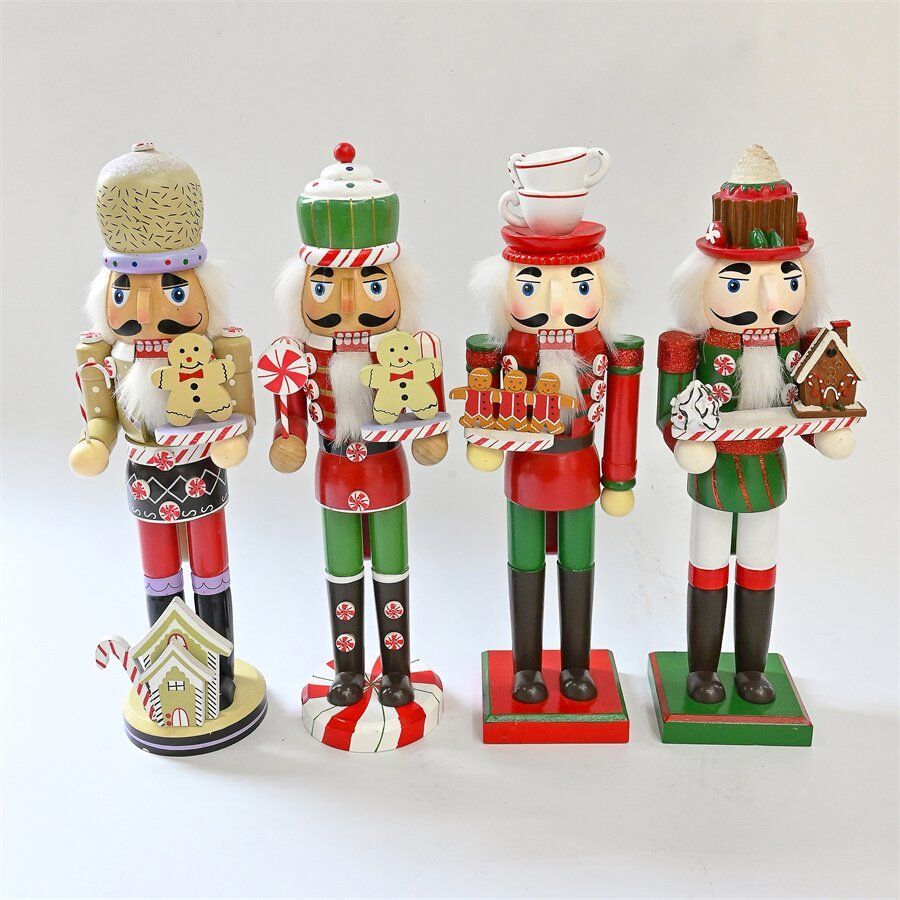 Cuatro cascanueces navideños en rojo, verde y blanco que sostienen golosinas en bandejas.