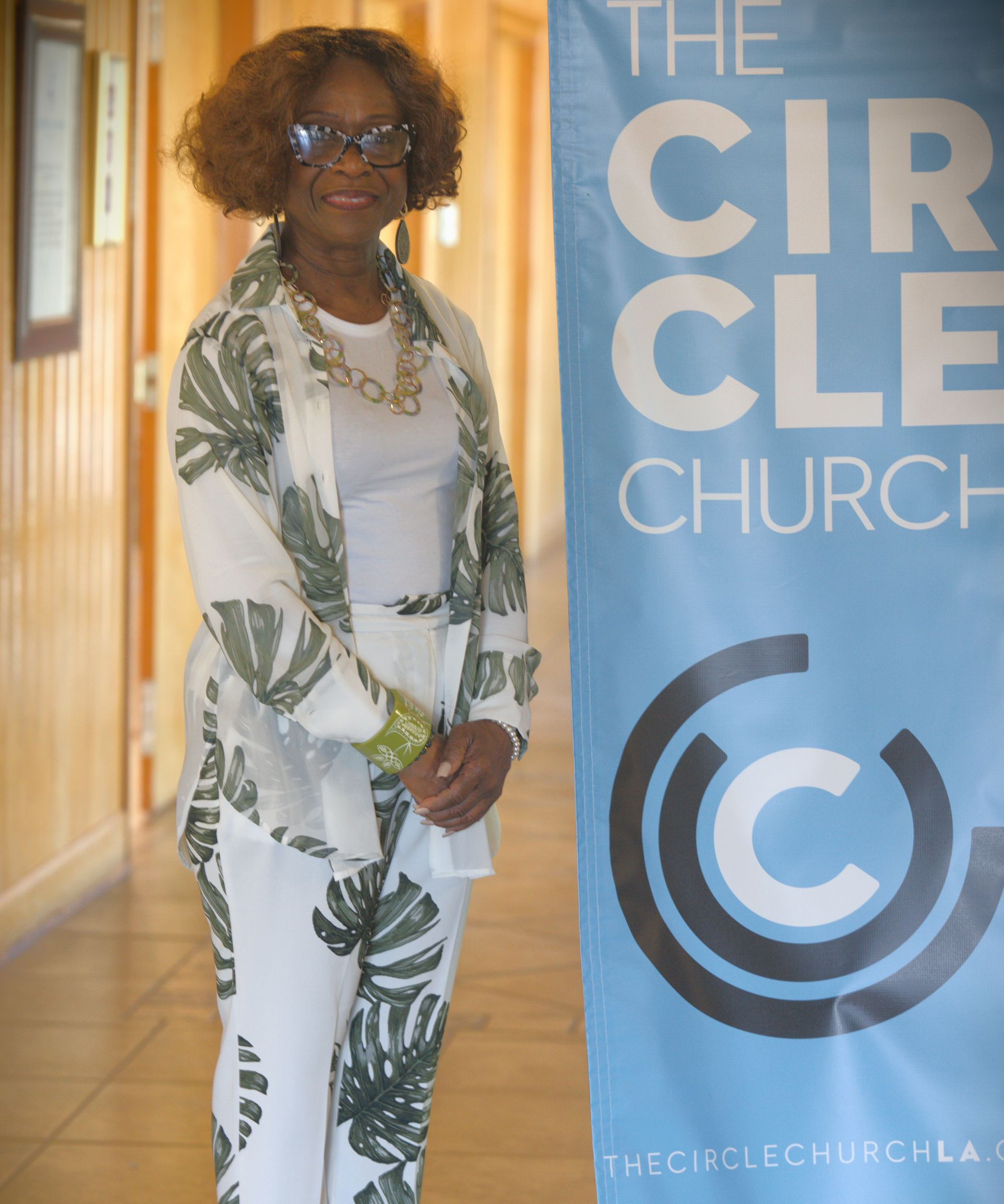 An African American woman waiting to greet members and guests at The Circle Church.