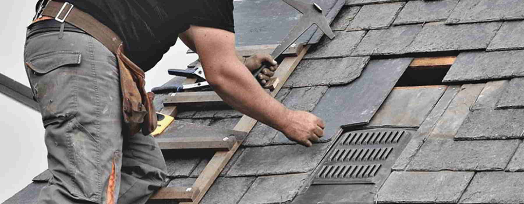 A man is working on the roof of a house.