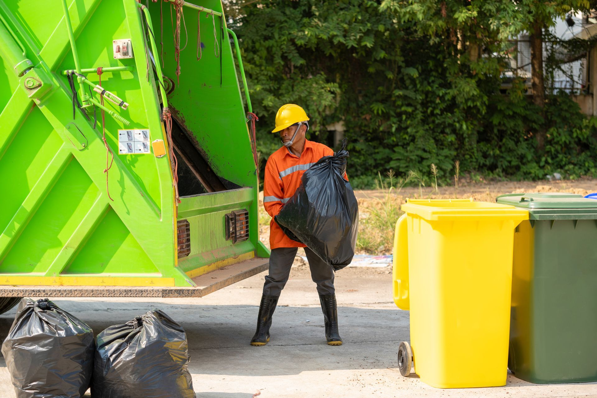 Worker operating garbage collector truck for efficient trash removal. Worker operating garbage collector truck for efficient trash removal.