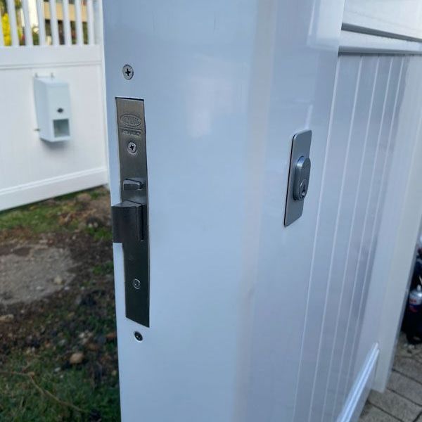 A close up of a white door with a lock on it.