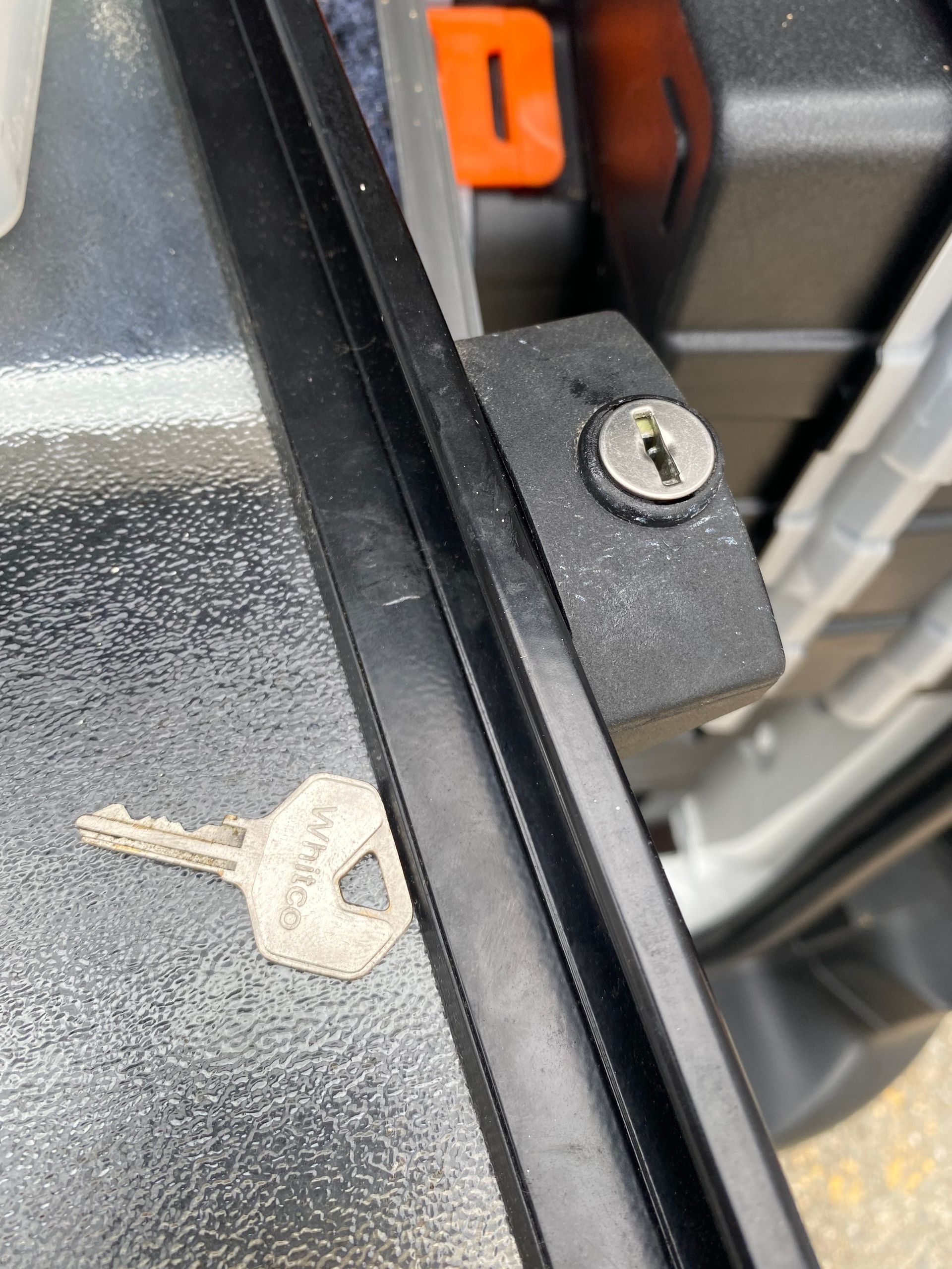 A close up of a key in a lock on a door.
