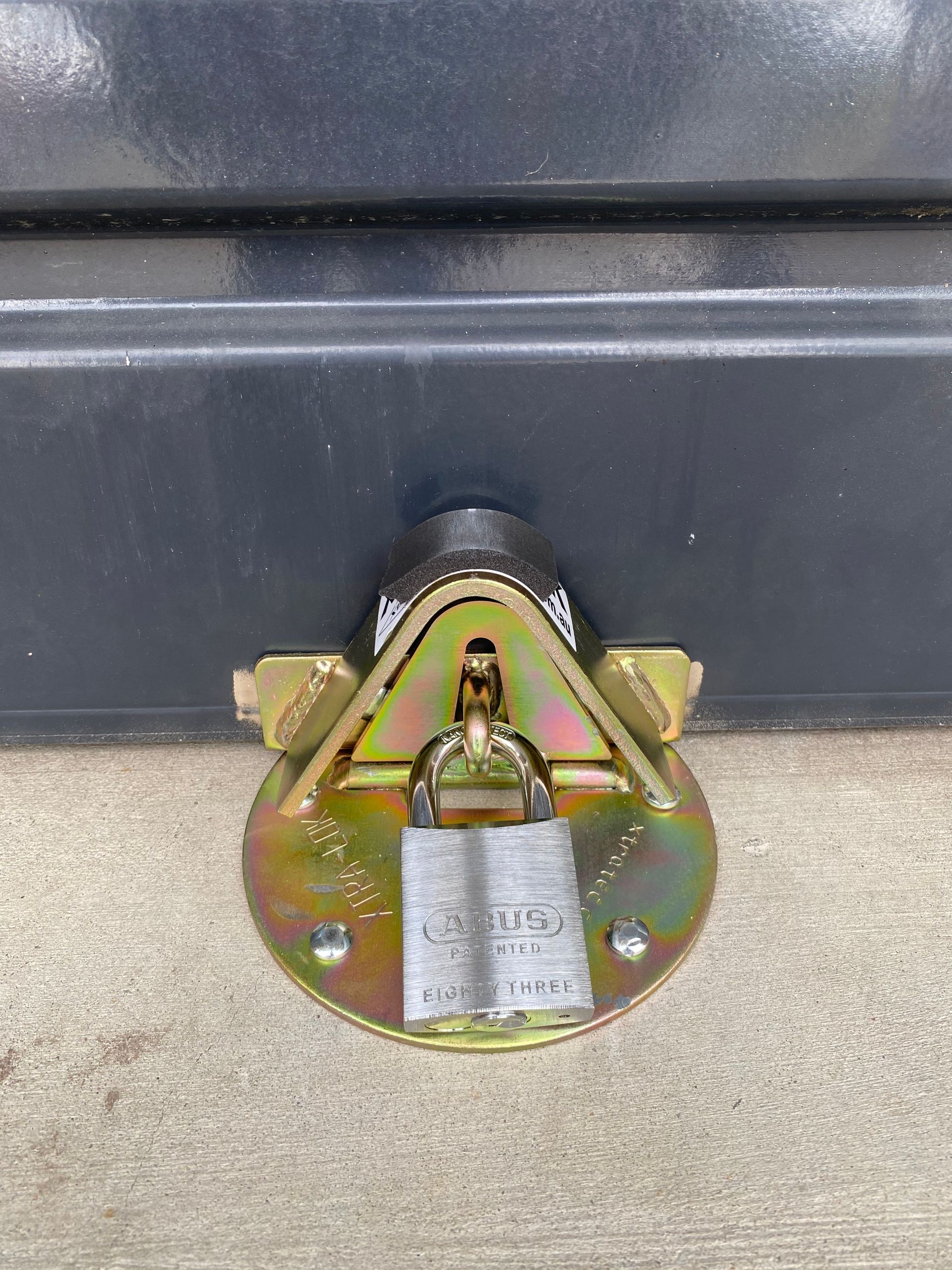 A padlock is attached to the side of a door.