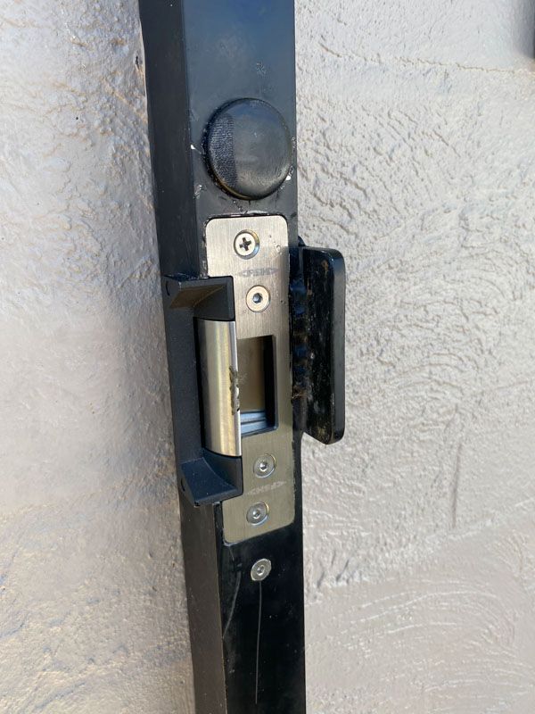 A close up of a door lock on a white wall.