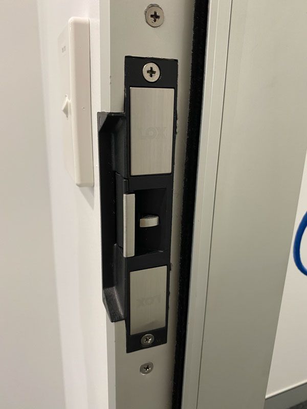 A close up of a door lock on a white door.