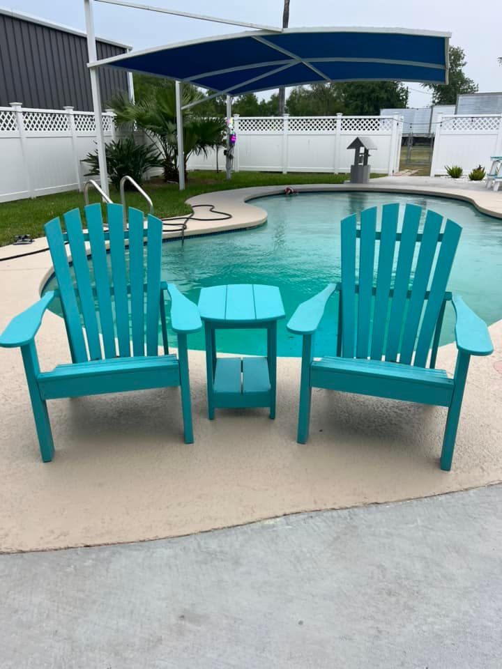Two blue adirondack chairs are sitting next to a pool