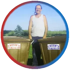 A man standing next to a trash can that says Chism's A man standing next to a trash can that says Chism's