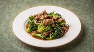 Stir-fried beef and broccoli served on a white plate