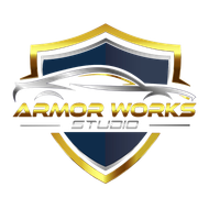 Shield logo with gold trim, a stylized silver car, and text "ARMOR WORKS STUDIO."