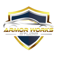 Shield logo with gold trim, a stylized silver car, and text "ARMOR WORKS STUDIO."