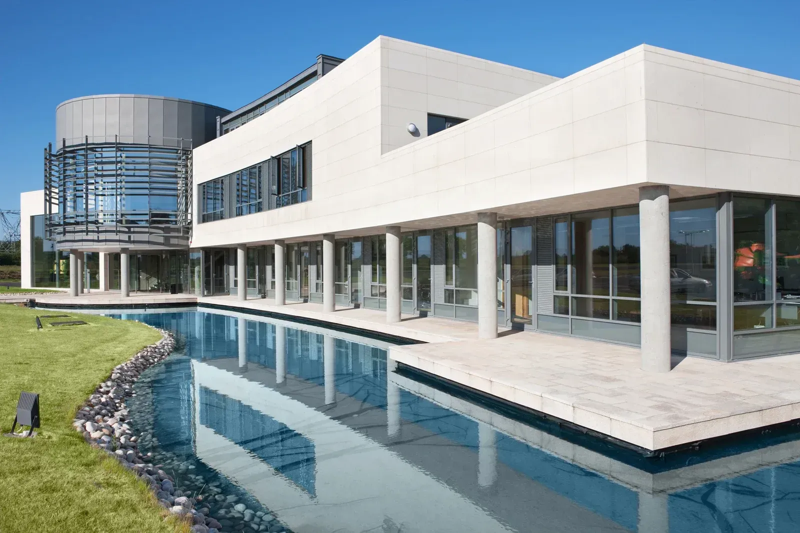 A large building with a swimming pool in front of it