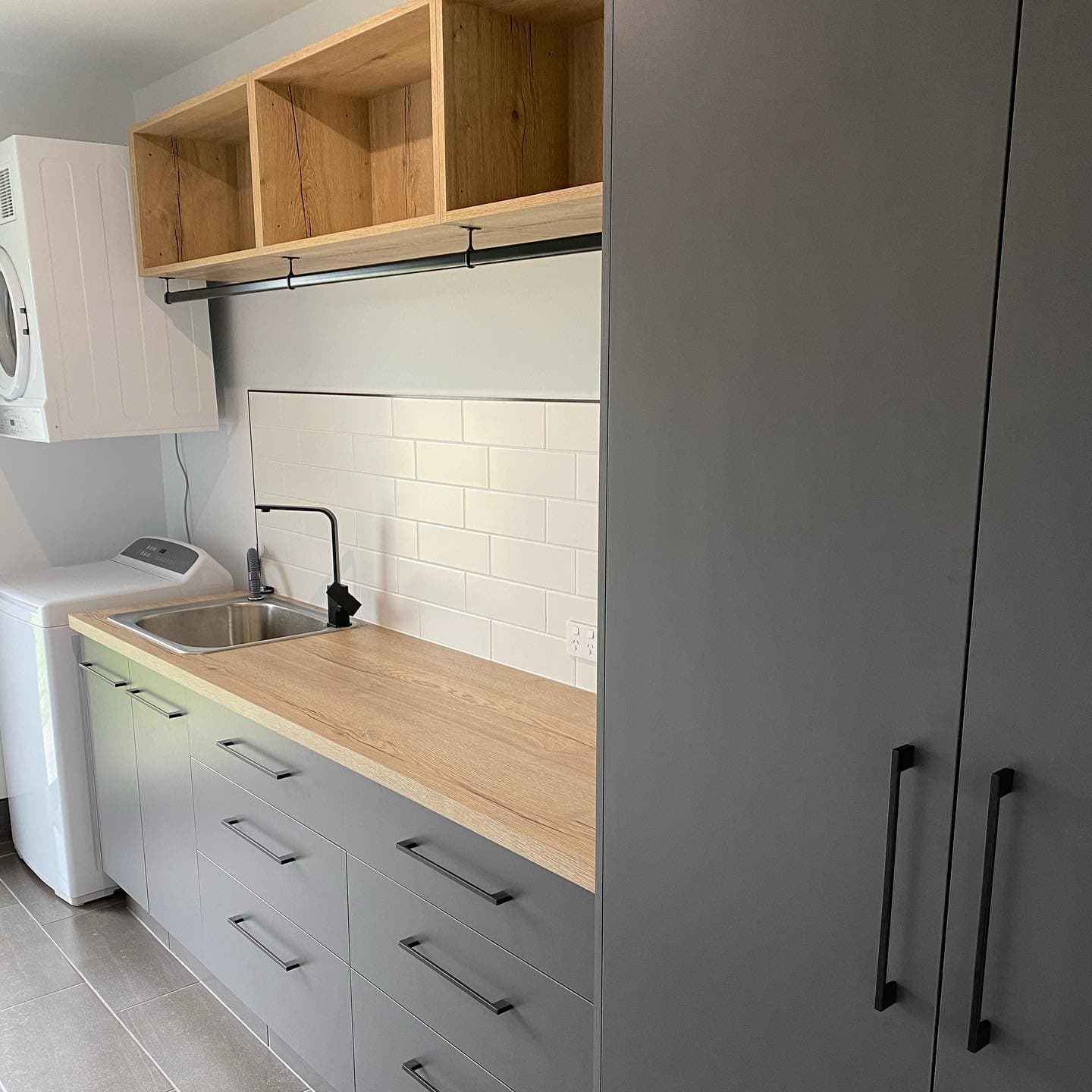 Grey Cabinets Installed in Laundry Room — Keppel Kitchens in Yeppoon, QLD