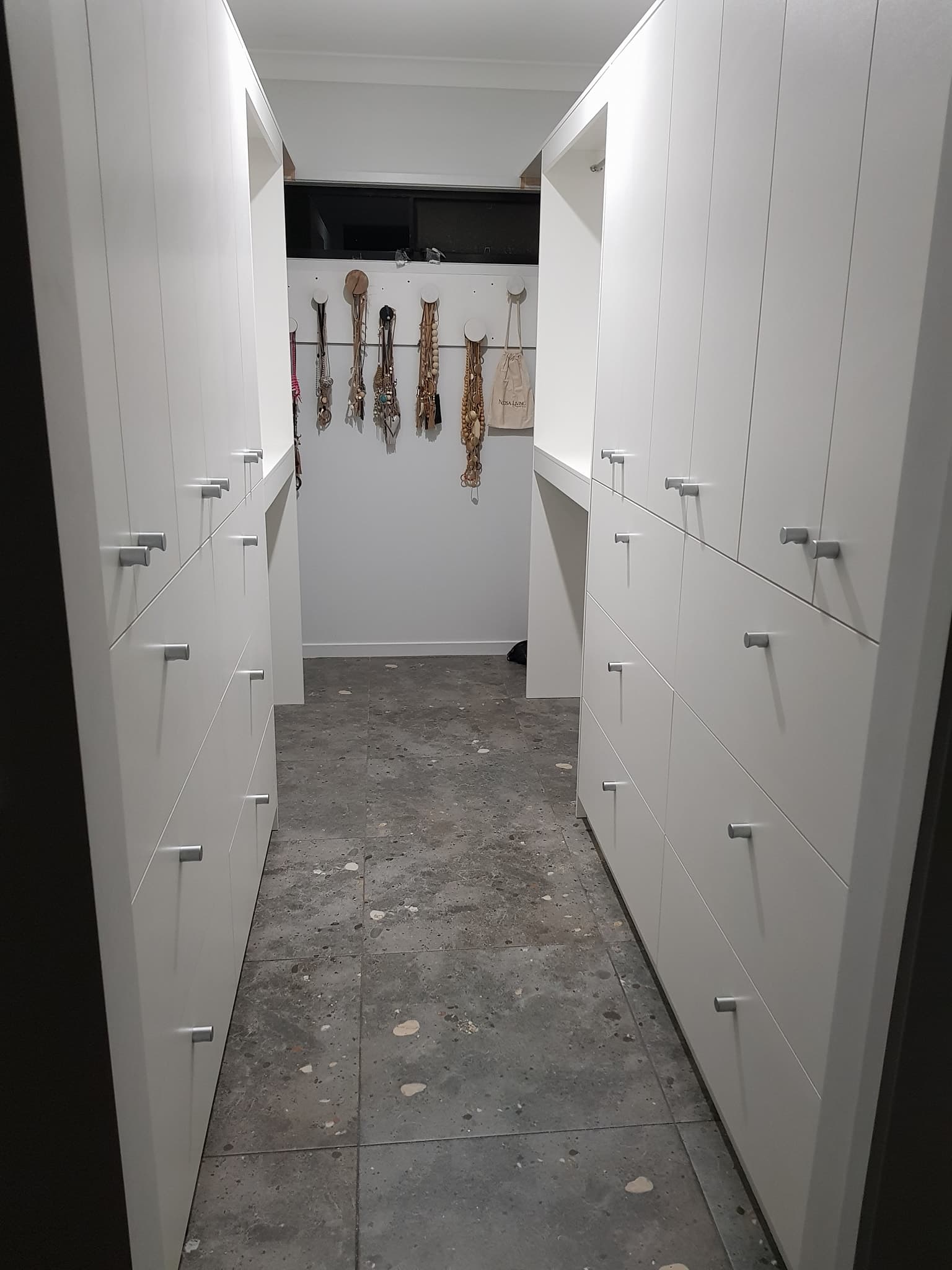 Walk-in Wardrobe with White Cabinet Doors — Keppel Kitchens in Yeppoon, QLD