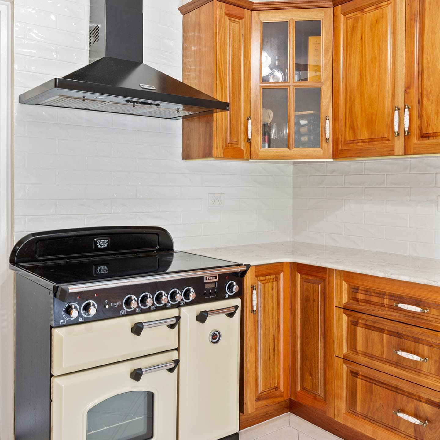 Electric Cooking Stove Beside the Wooden Cabinets — Keppel Kitchens in Yeppoon, QLD