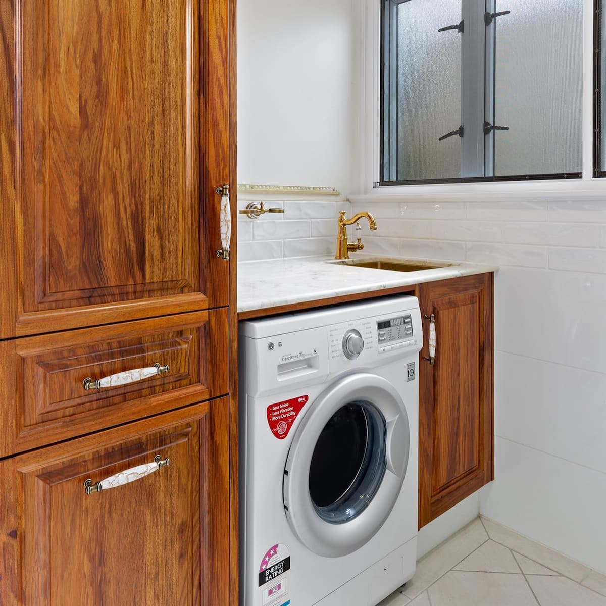 Gold and Wooden Interior Theme in Laundry Area — Keppel Kitchens in Yeppoon, QLD