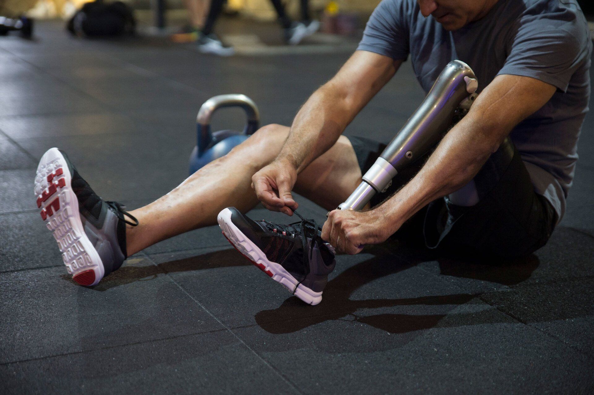 Man Sitting on the Floor in the Gym — Pembroke Pines, FL — Huse Artificial Limb & Brace