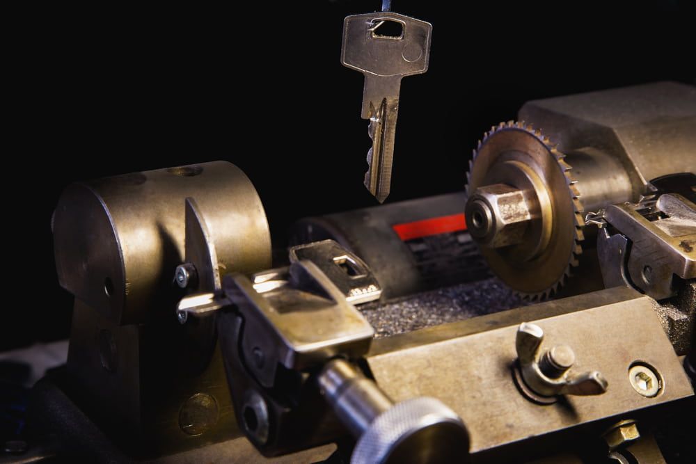 A Key Is Being Cut in A Machine — East Coast Locksmiths in Port Macquarie, NSW