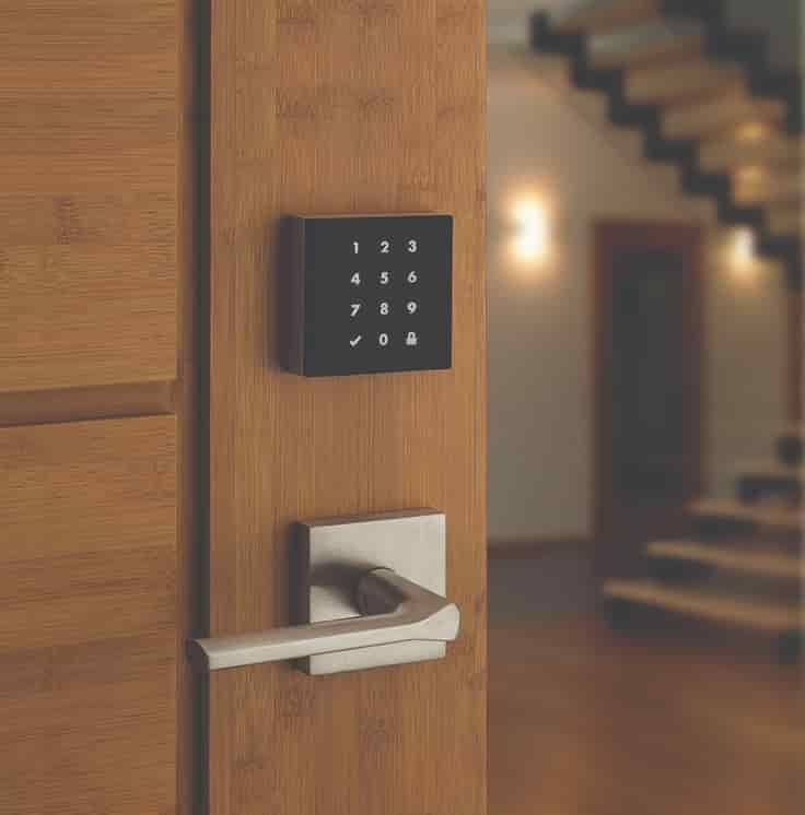 A Wooden Door with A Keypad on It and A Staircase in The Background — East Coast Locksmiths in Lake Cathie, NSW