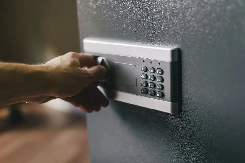 A Person Is Opening a Safe with A Keypad — East Coast Locksmiths in Port Macquarie, NSW