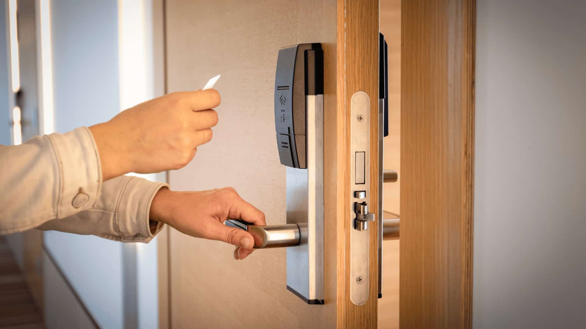 A Person Is Opening a Door with A Card — East Coast Locksmiths in Port Macquarie, NSW