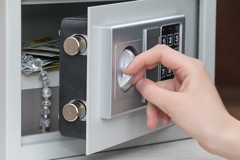A Person Is Opening a Safe with A Bracelet in It — East Coast Locksmiths in Lake Cathie, NSW