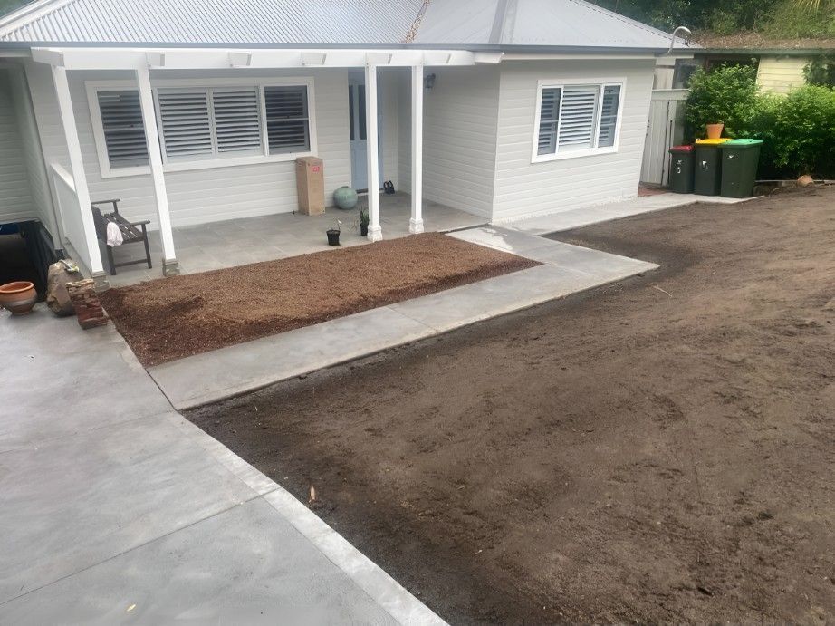 A House With a Porch and a Concrete Walkway in Front of It — Superior Turf in Bowral, NSW
