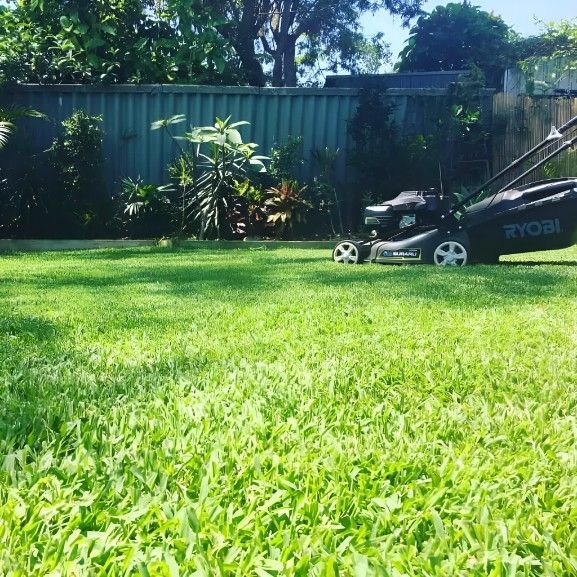 A Lawn Mower is Sitting on Top of a Lush Green Lawn — Superior Turf In Shoalhaven, NSW