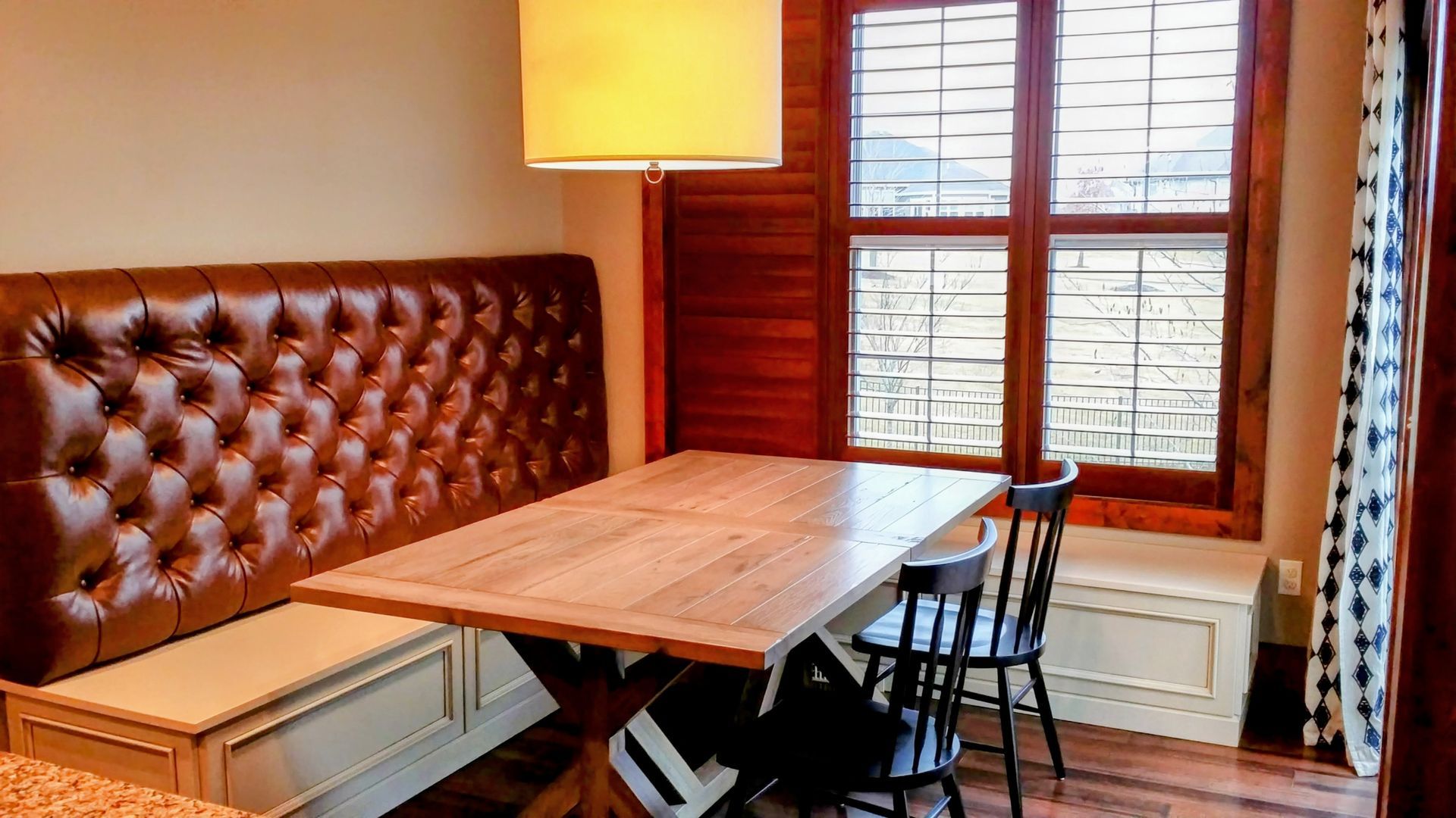 A custom dining room with a table and bench in Columbia, Missouri.