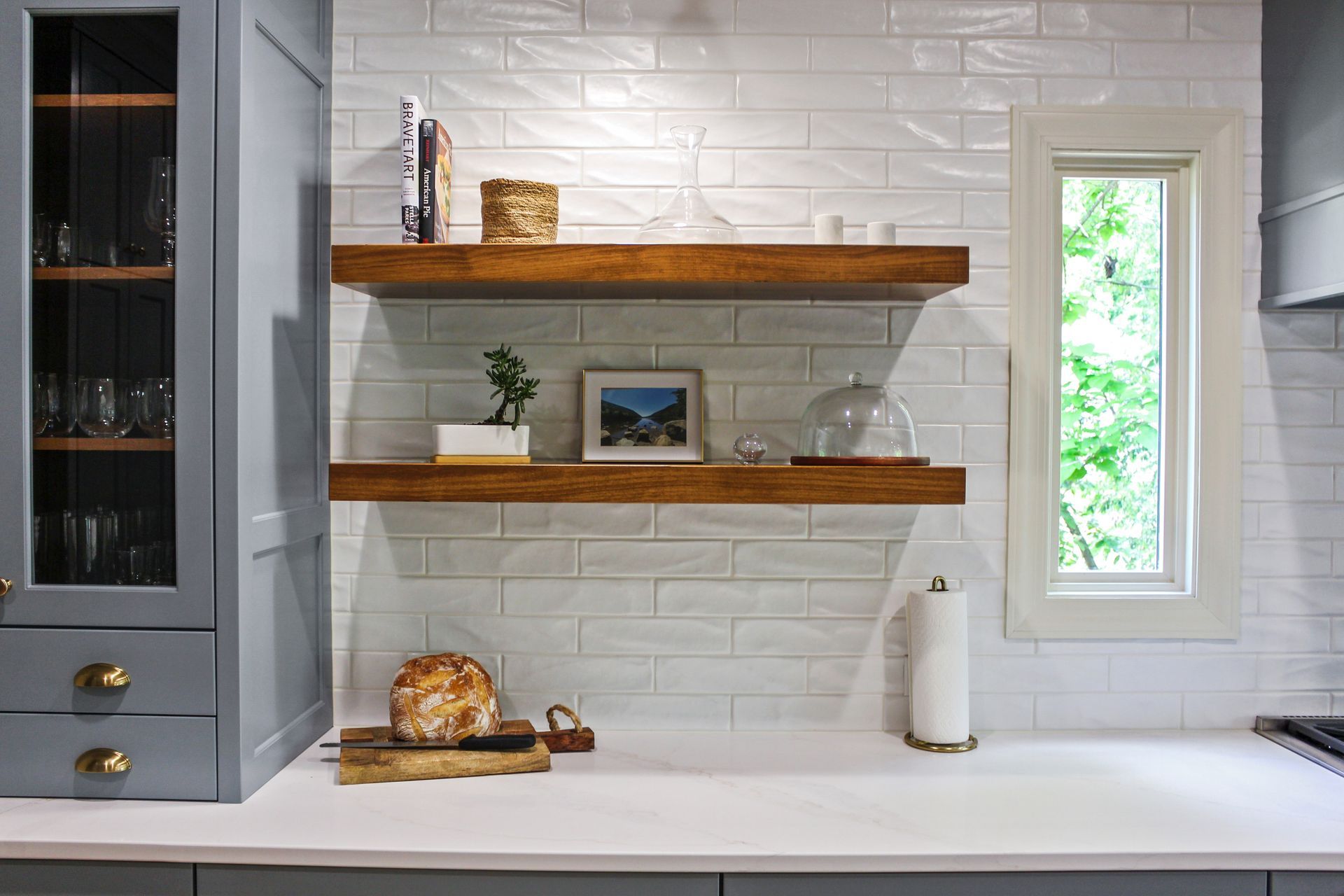 A kitchen with custom floating wooden shelves. Custom cabinets Columbia Missouri 