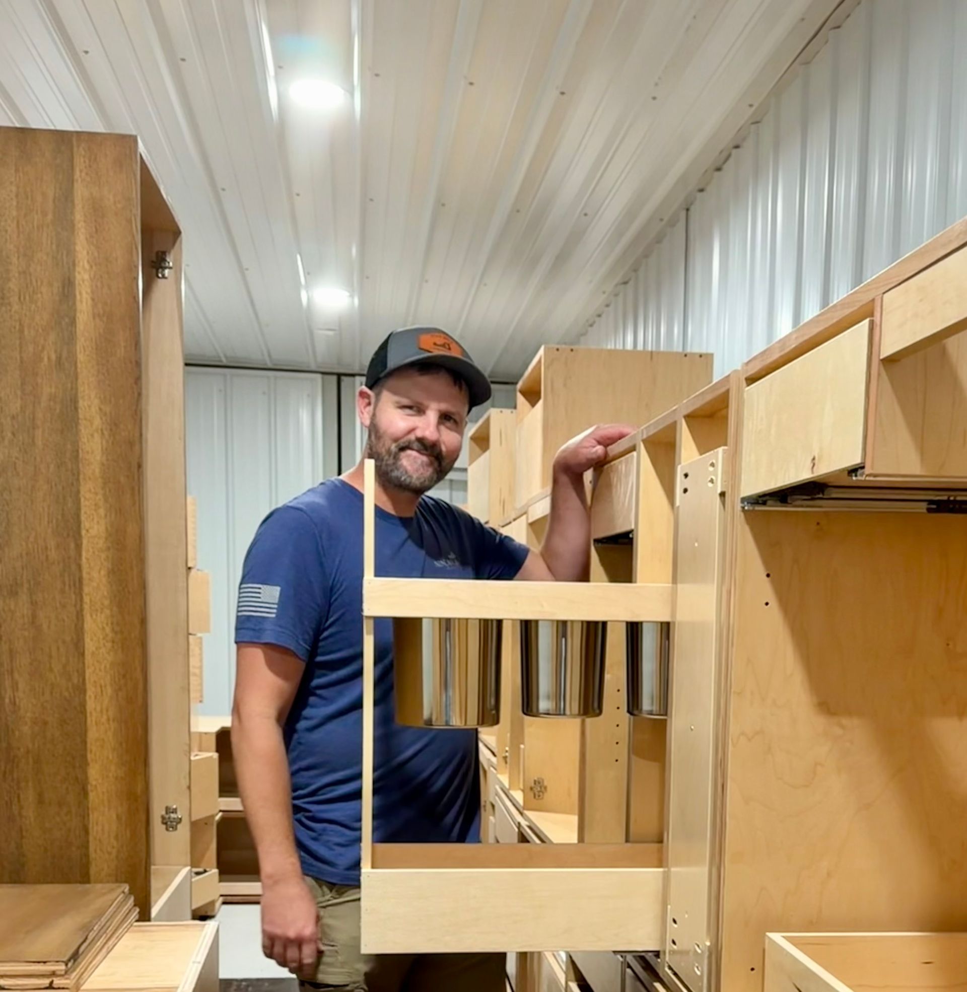 Owner Andrew showing one of many storage options that Nine Mile Cabinetry can make.