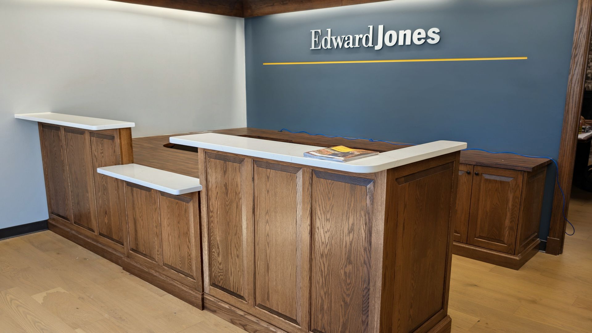 Custom wood commercial reception desk and office cabinetry for a professional business suite in Mexico MO. 
