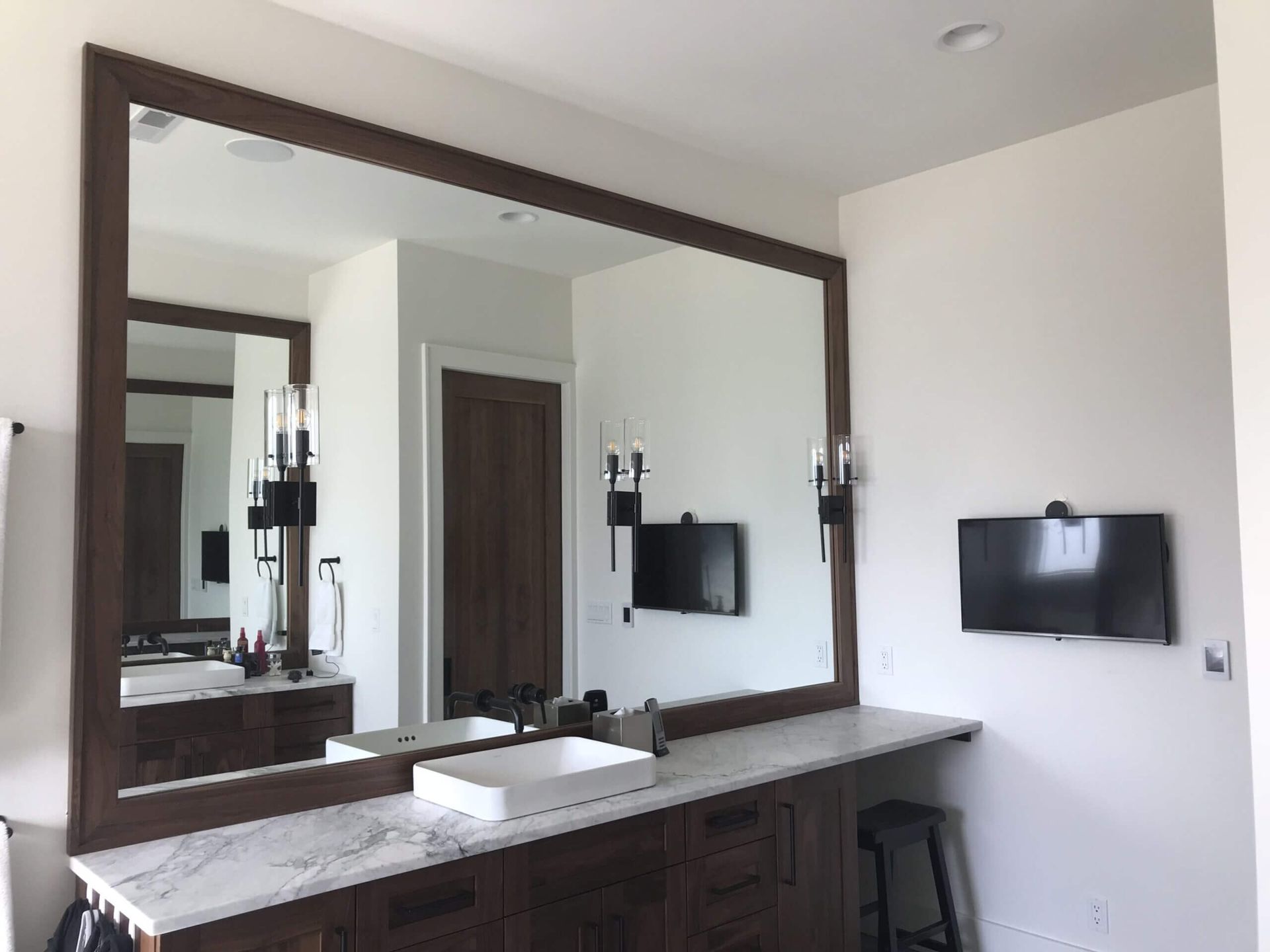 A bathroom with two sinks and a large mirror. Custom cabinets Columbia Missouri 