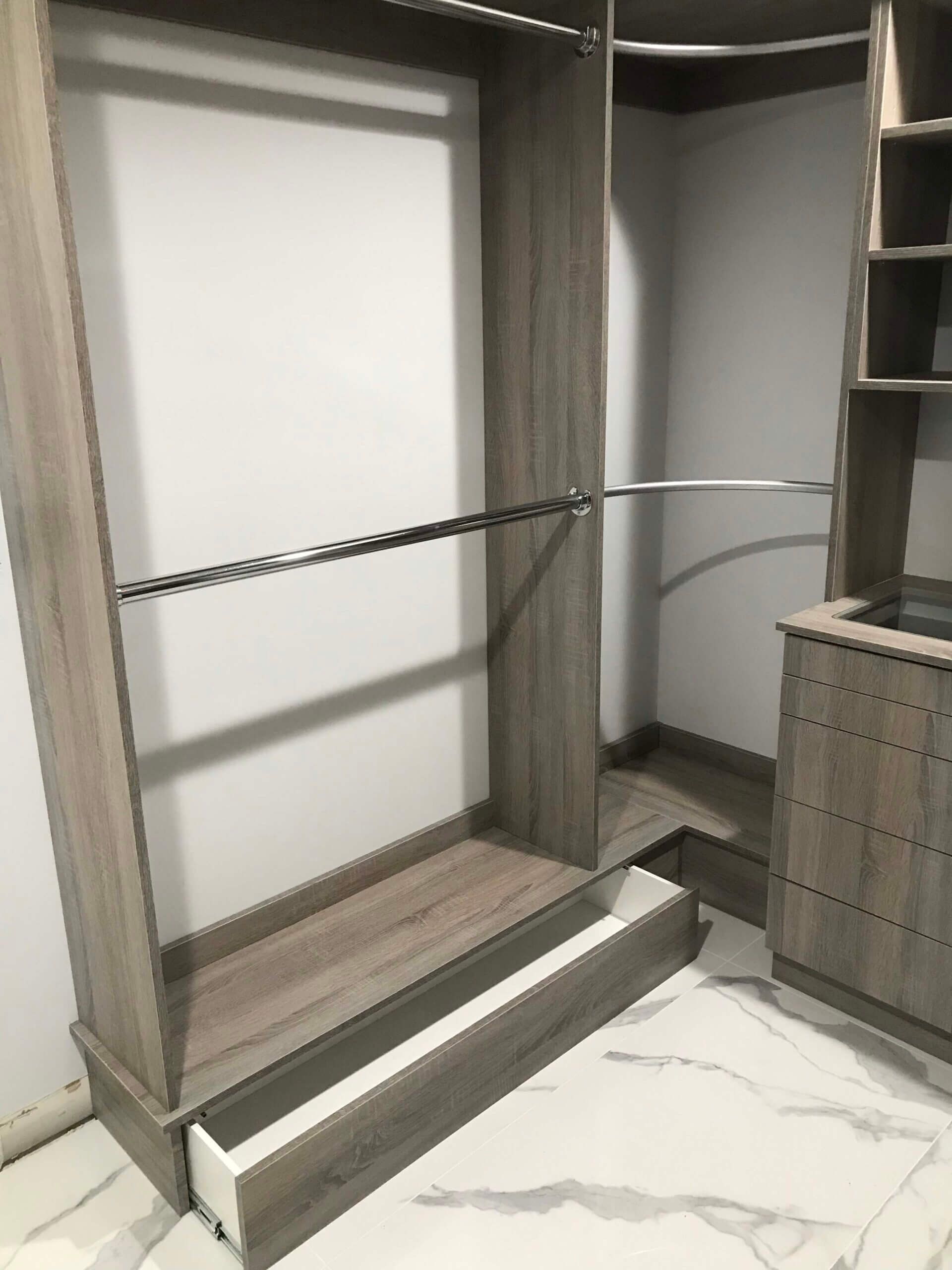 A custom closet with hanging rod and drawers in Fulton MO.