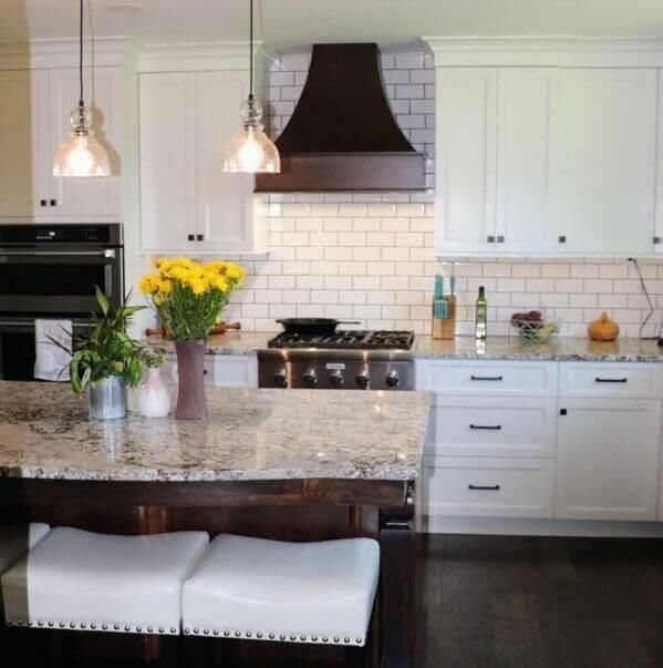 A kitchen with white cabinets and granite counter tops. Custom cabinets Columbia Missouri 
