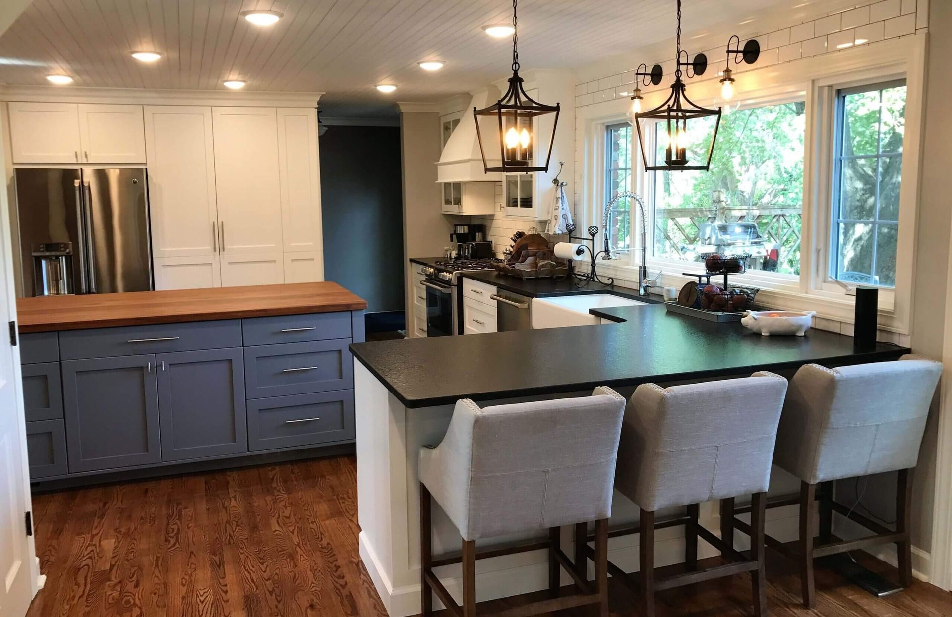 A kitchen with a large island and stools. Custom cabinets Columbia Missouri 