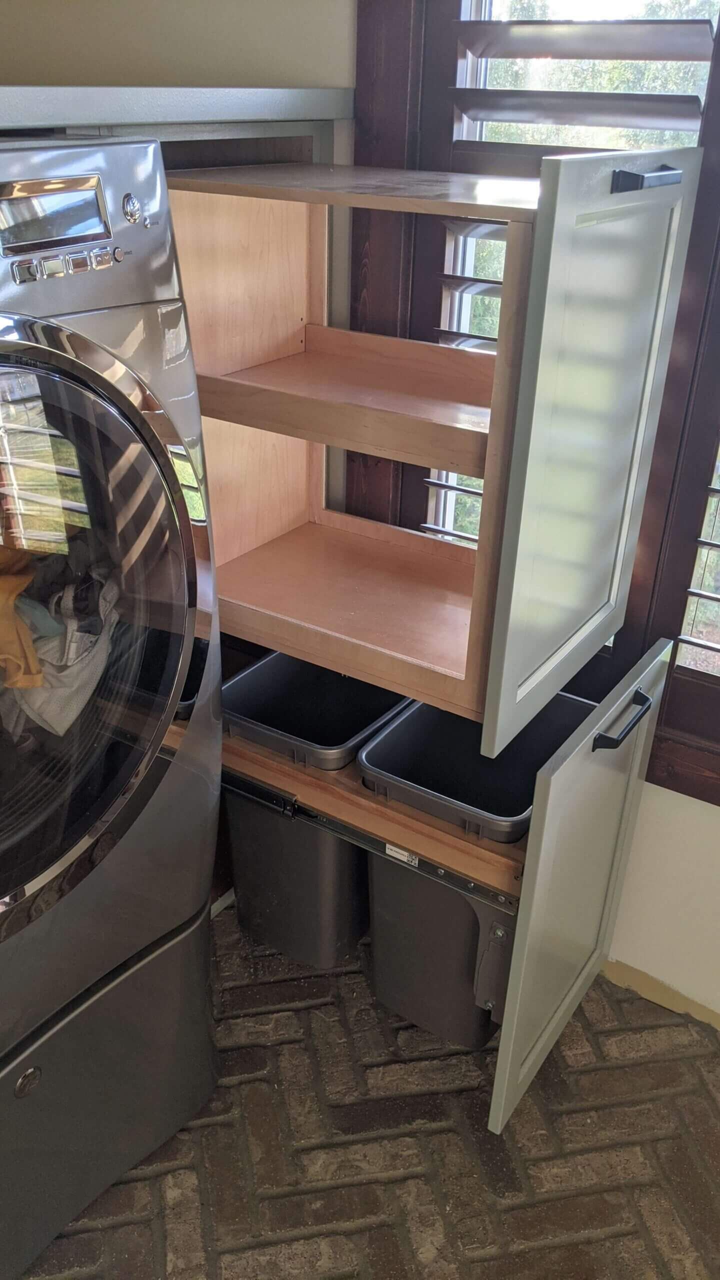 A washer and dryer are sitting next to each other in a laundry room.